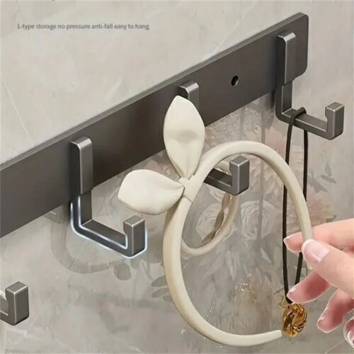 Slim aluminium wall-mounted rack with seven hooks spaced at 9 cm intervals