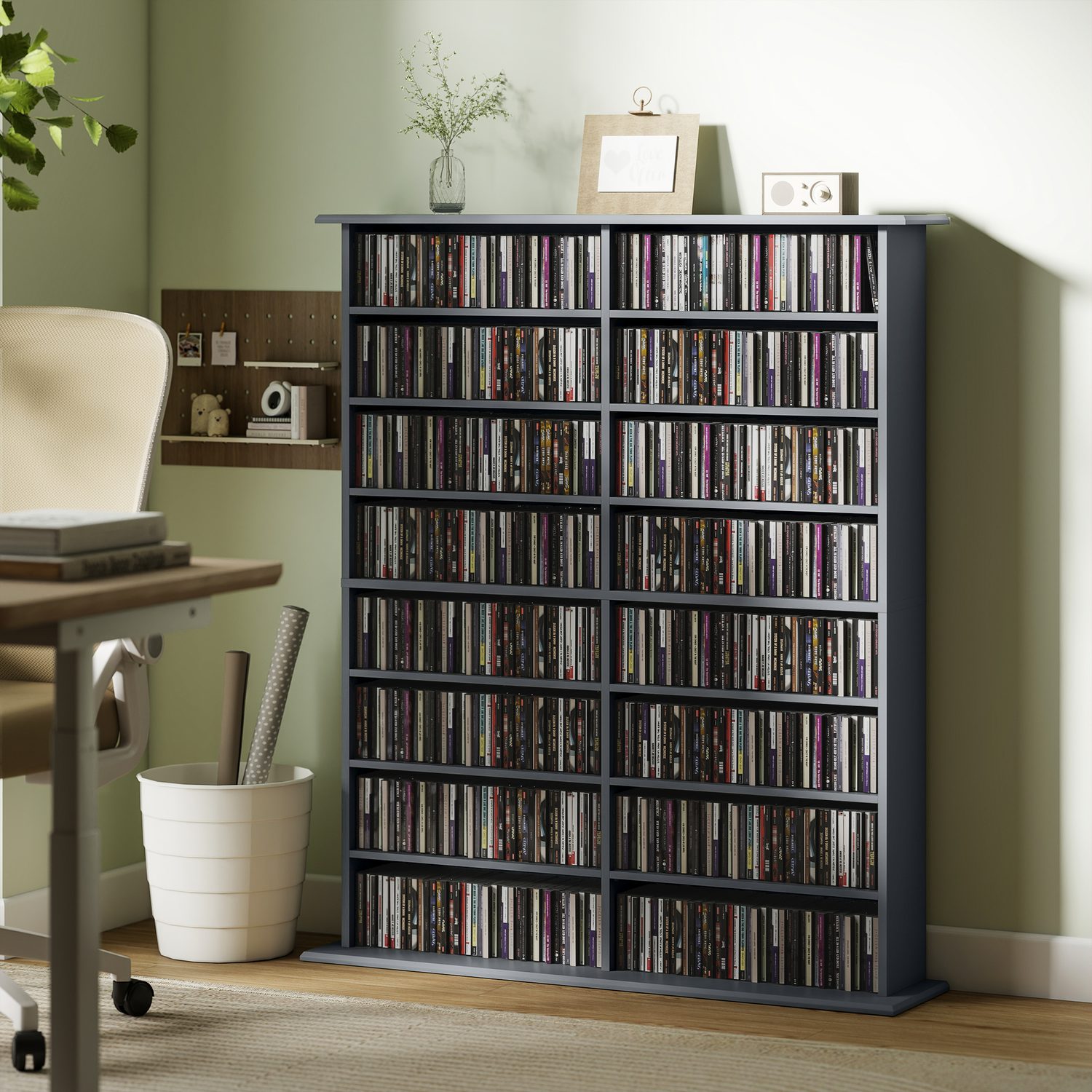 Sixteen-compartment dark grey media shelf holding vinyl records and CDs in a UK living room