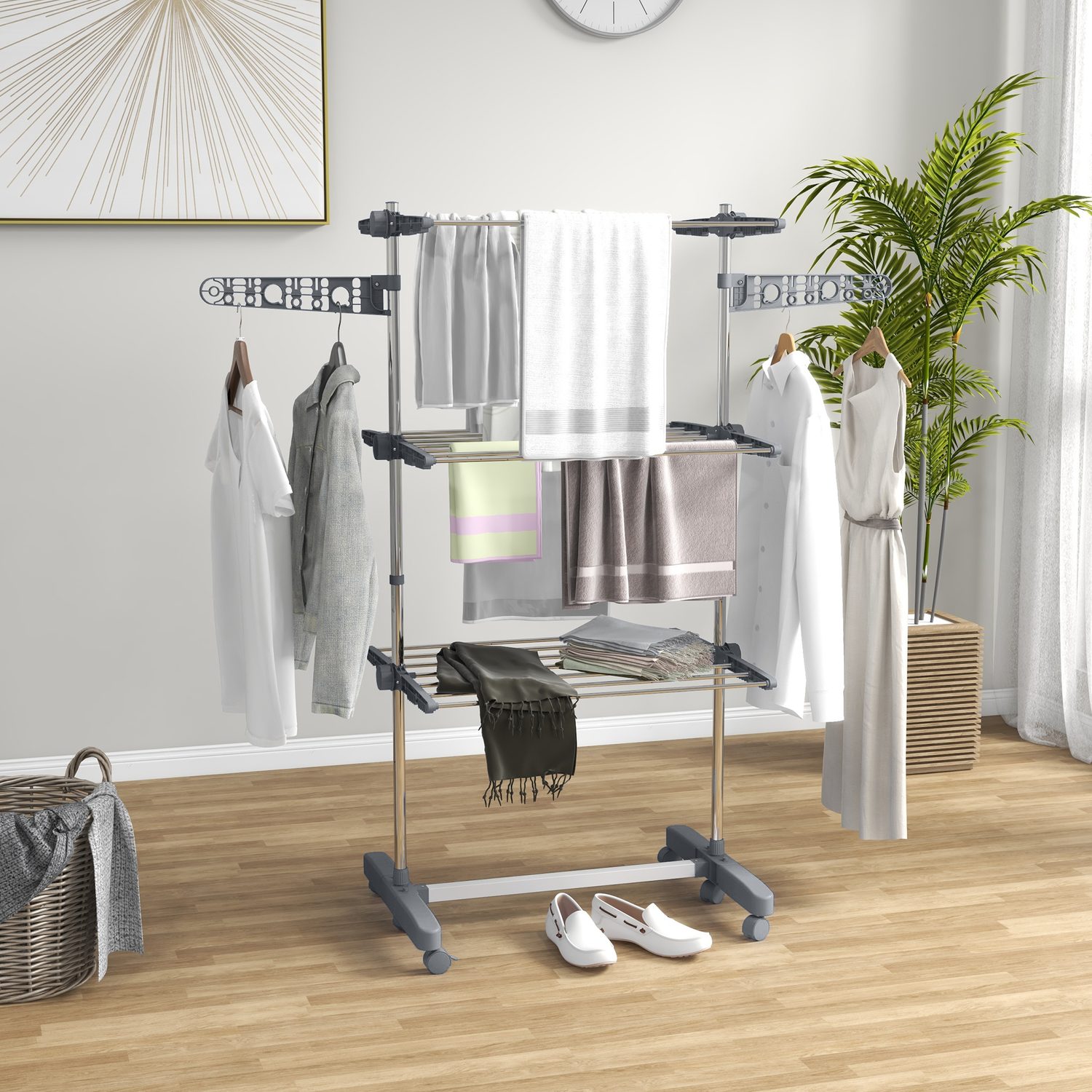 Grey three-shelf folding clothes horse with two side wings folded out and locking castors.