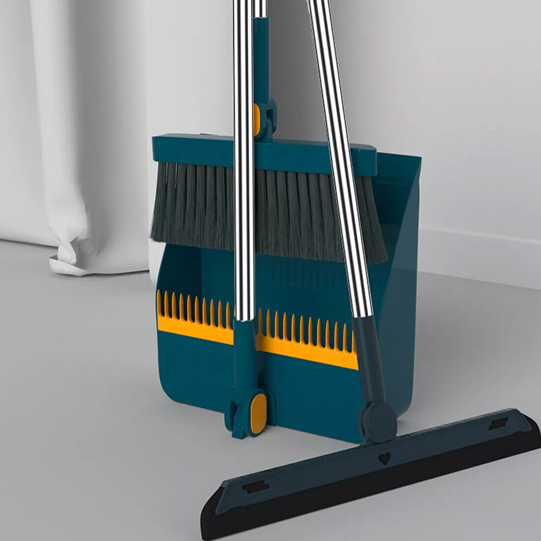 A teal long-handle dustpan and brush set with metal handles and a folding pan