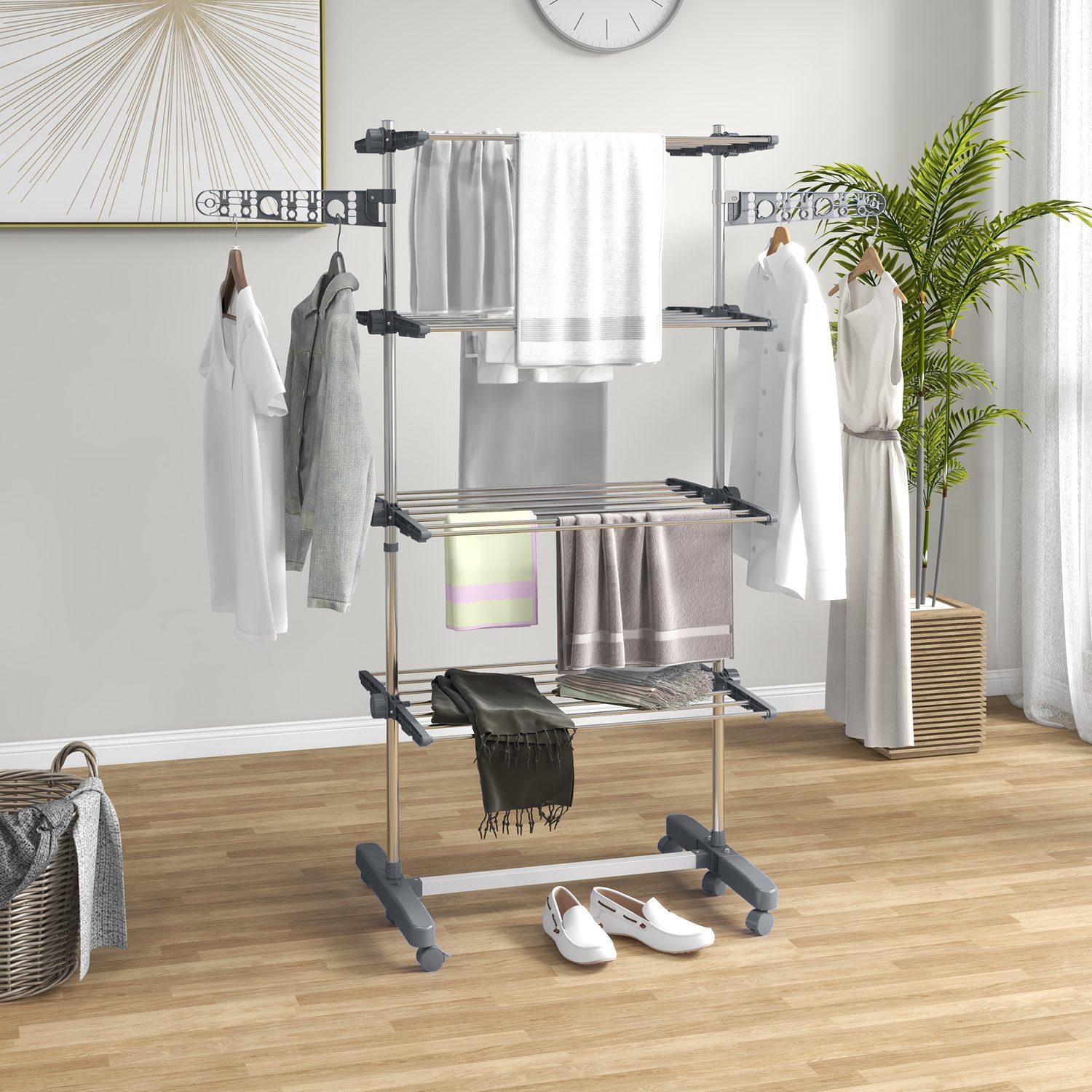 Tall four-shelf grey clothes horse with two folding side wings and six wheels.
